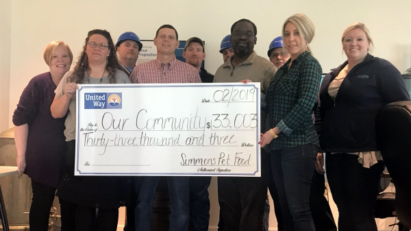Representatives of Simmons Pet Food pose with a check representing the facility’s donations to the United Way of the Flint Hills.