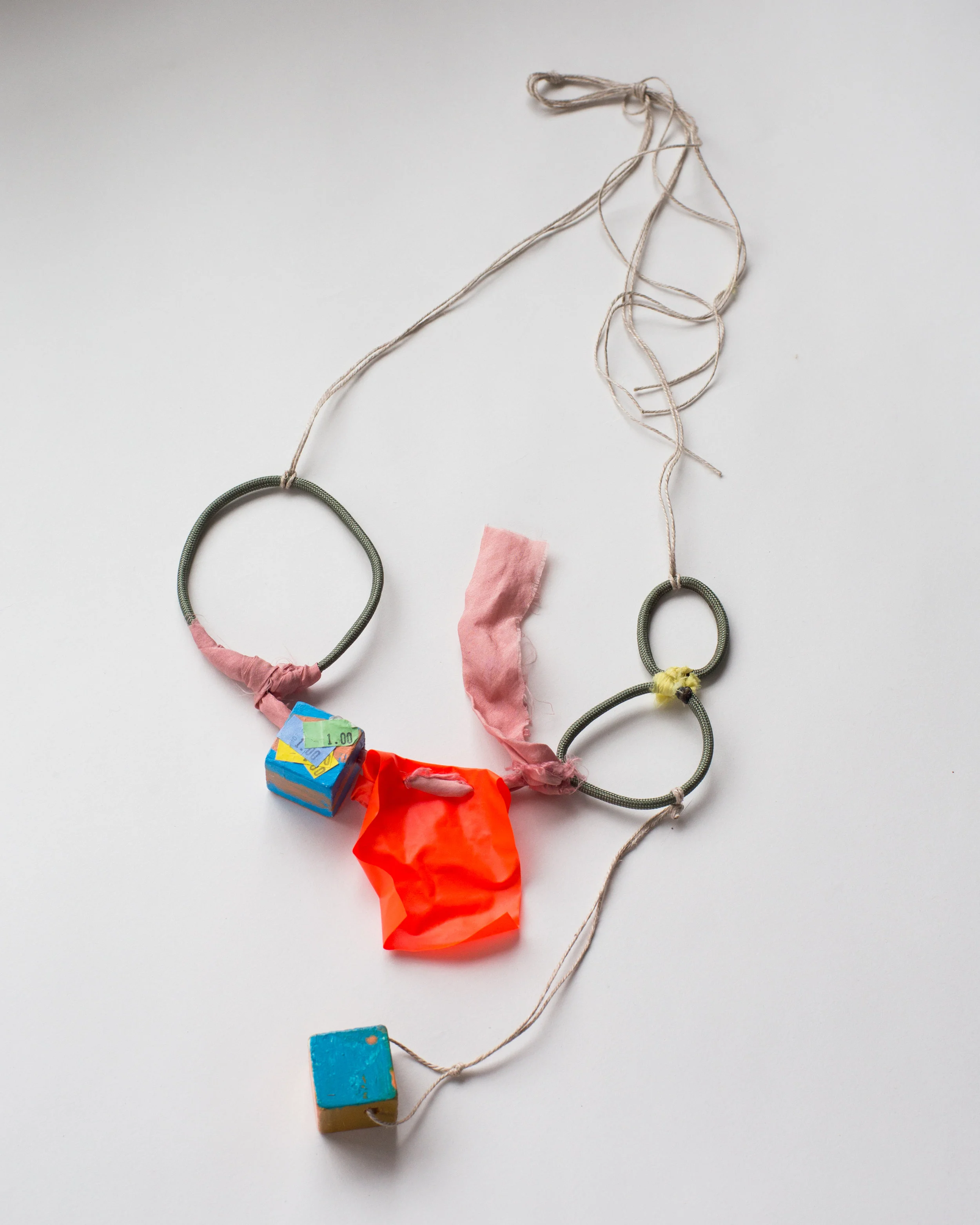   $1 Necklace , Lac and weld on silk, para cord, linen, landscaping flag, wood, acrylic paint, price tags   