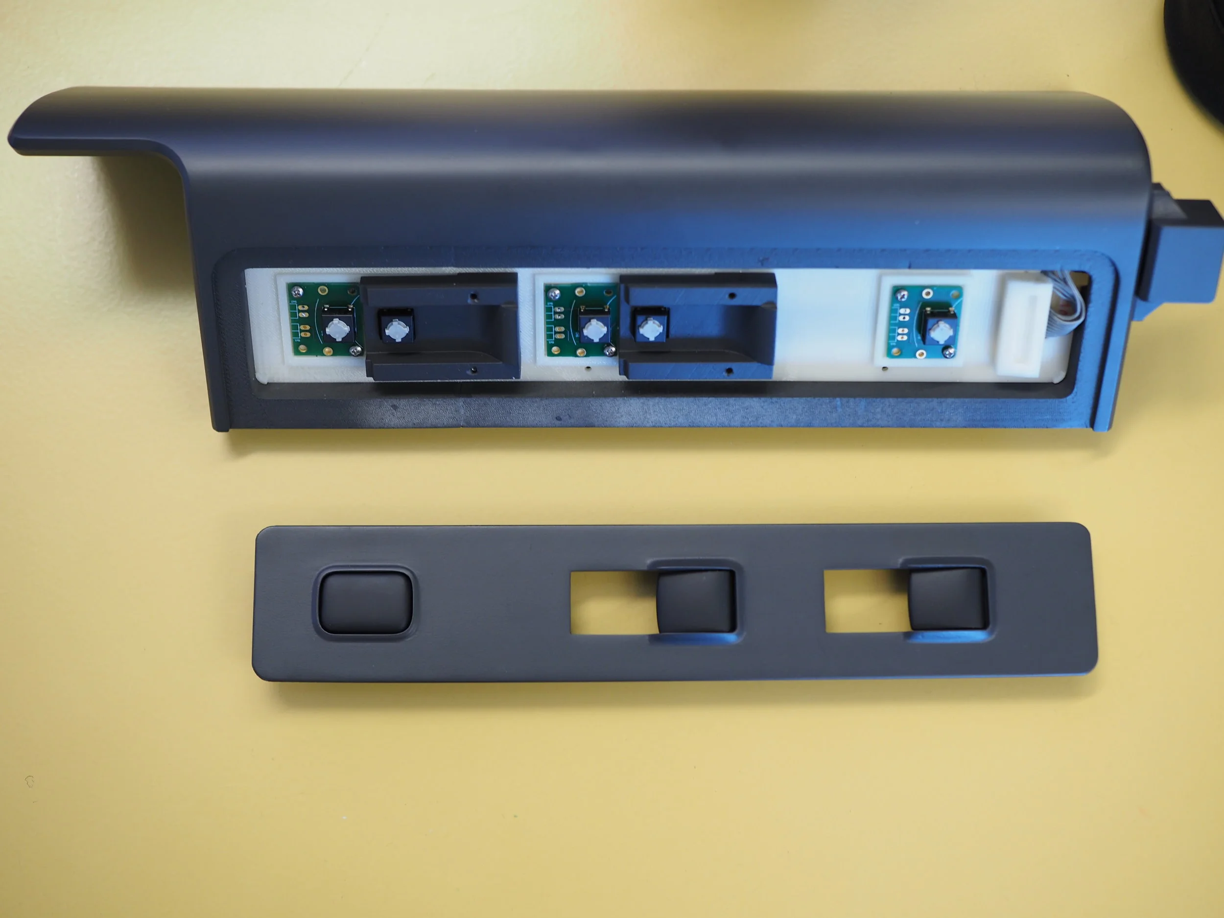 Momentary buttons for window controls located on the side door arm rest