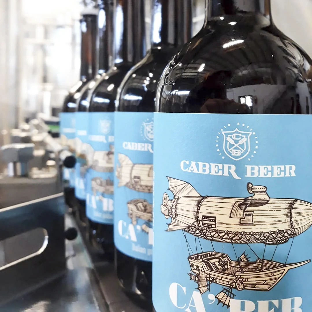 Craft beer being bottled and labeled.