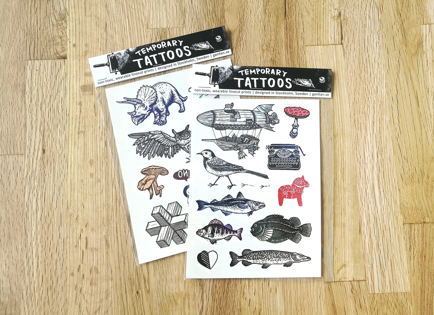Two temporary tattoo sheets based on Tian’s linocut designs.