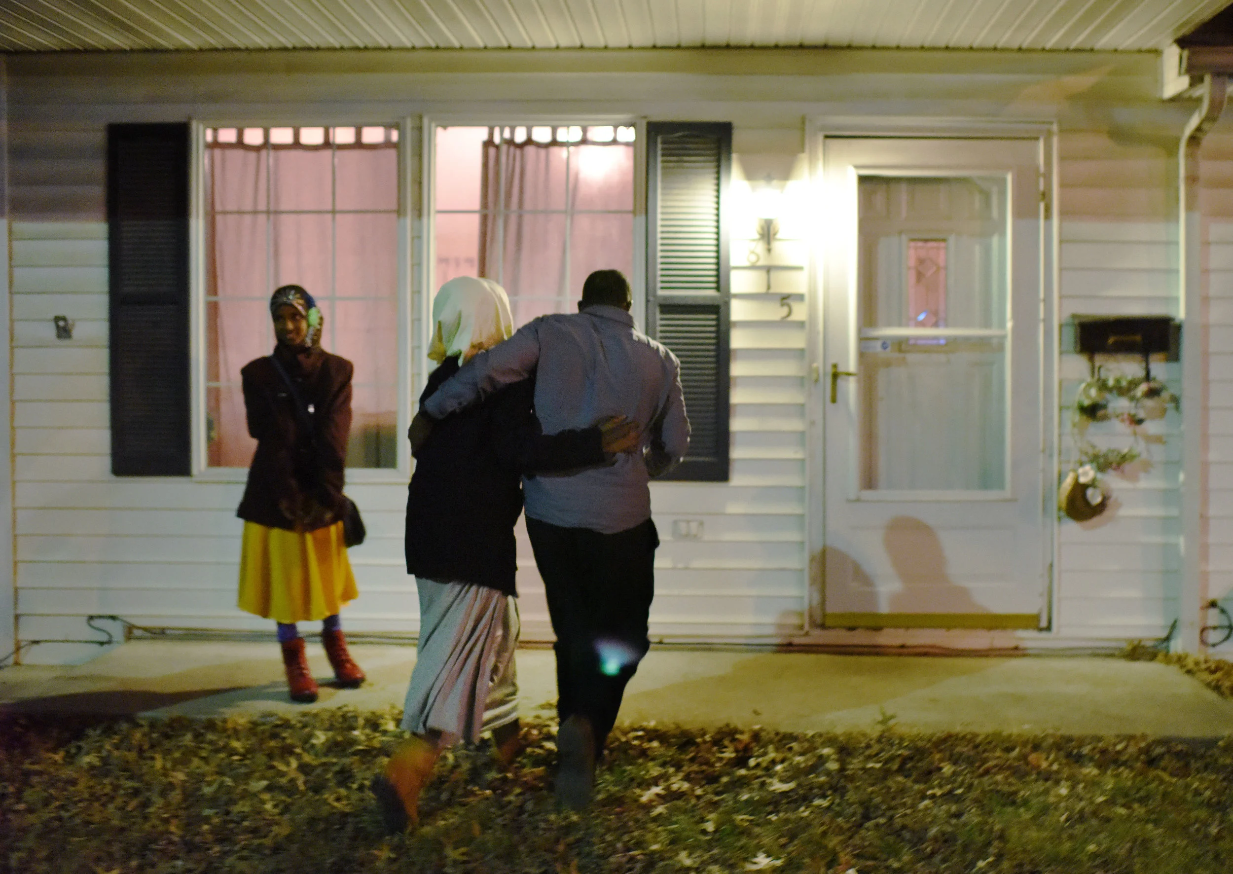 From left, Aniso Abdirahman, 12, Iqro Abdirahman, 13, and Abshir Abdirahman walk into their home after the family arrived in Columbia on Friday, Feb. 17, 2017. Abshir works two jobs to support his family.