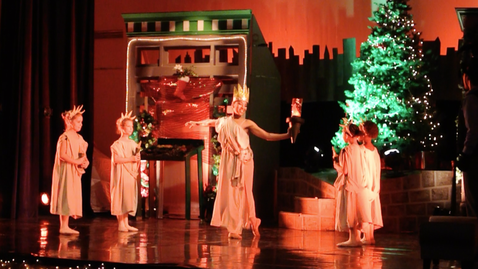 A dancing Statue of Liberty surrounded by Liberty Angels