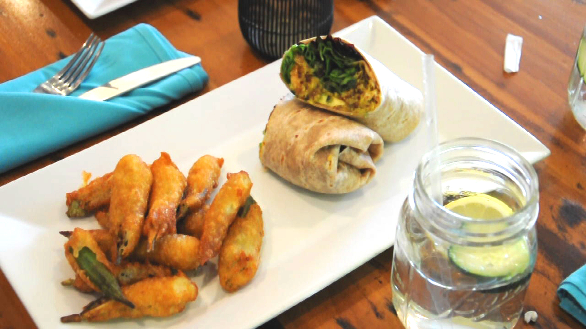 Jerk portabella mushroom wrap with avocado, mixed greens, tomatoes, and a side of okra fries 