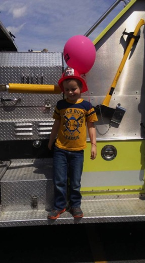 A young festival attendee determining whether or not he wants to become a firefighter when he grows up. Photo courtesy of Shoprite of Brooklawn Spring Festival Facebook page.