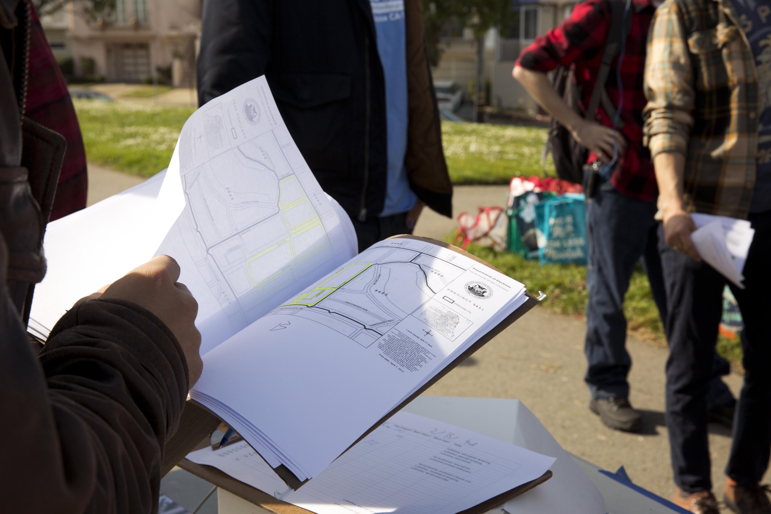 Otto Pippenger flips through his canvassing binder