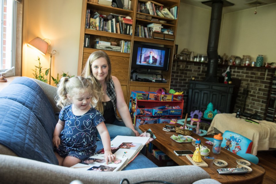 Judi Hundemann's fiancee, Michael Burke an Afghanistan combat veteran, committed suicide in October of 2015. Here, Judi and their daughter Arya Burke, 3, look at photos that include Michael. / Russ DeSantis | For NJ Advance Media