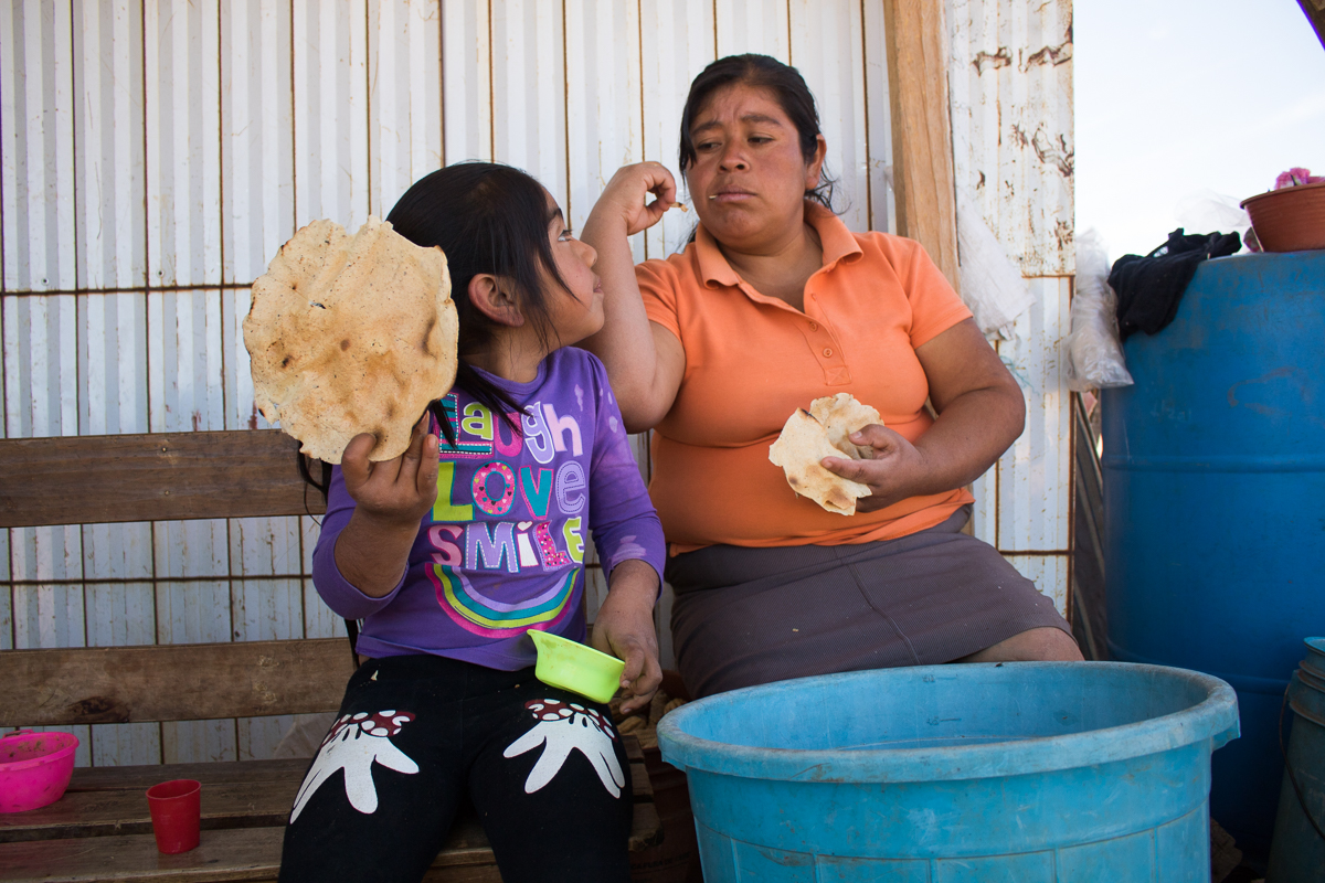 Lucero Vargas, left, 6, eats a tortilla with her mother, Herminia Vargas, 32, at their home in Zaachila, Mexico on Thursday, Jan. 12, 2017.