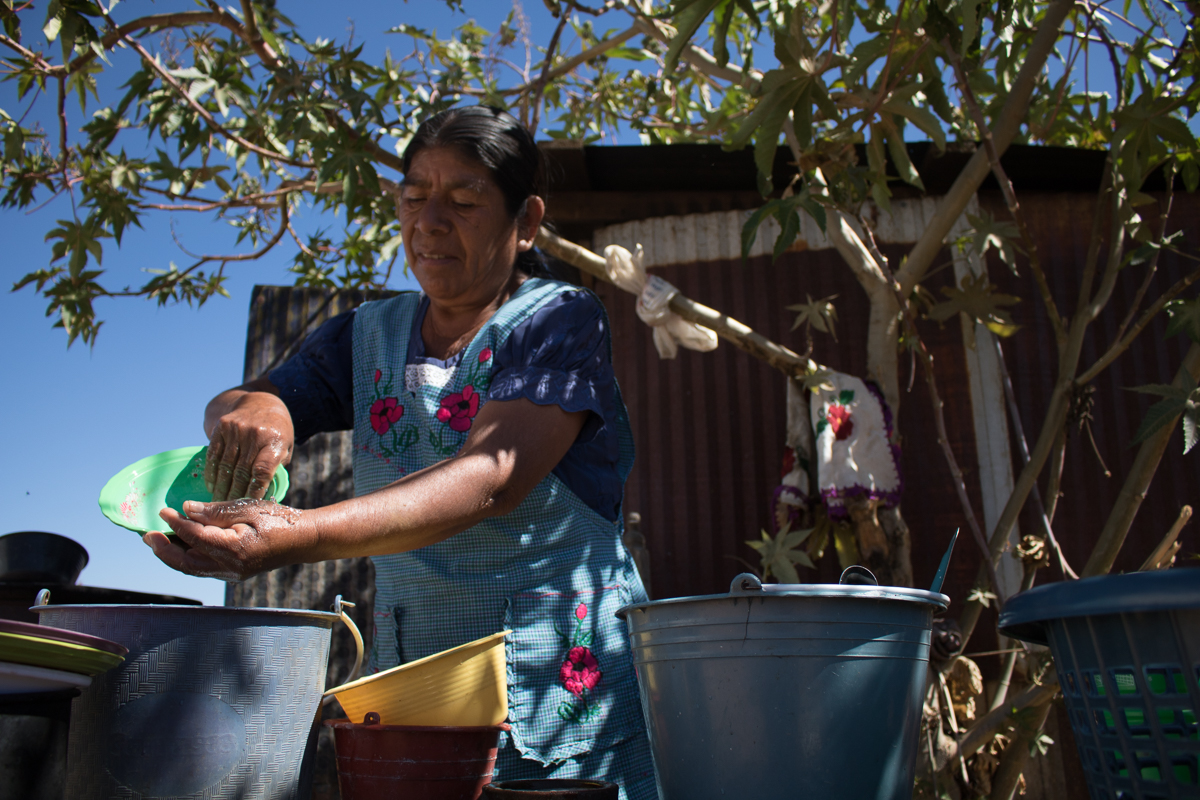 Auria Vargas, 63, cleans dishes outside of her home in Zaachila, Mexico on Thursday, Jan. 12, 2017.