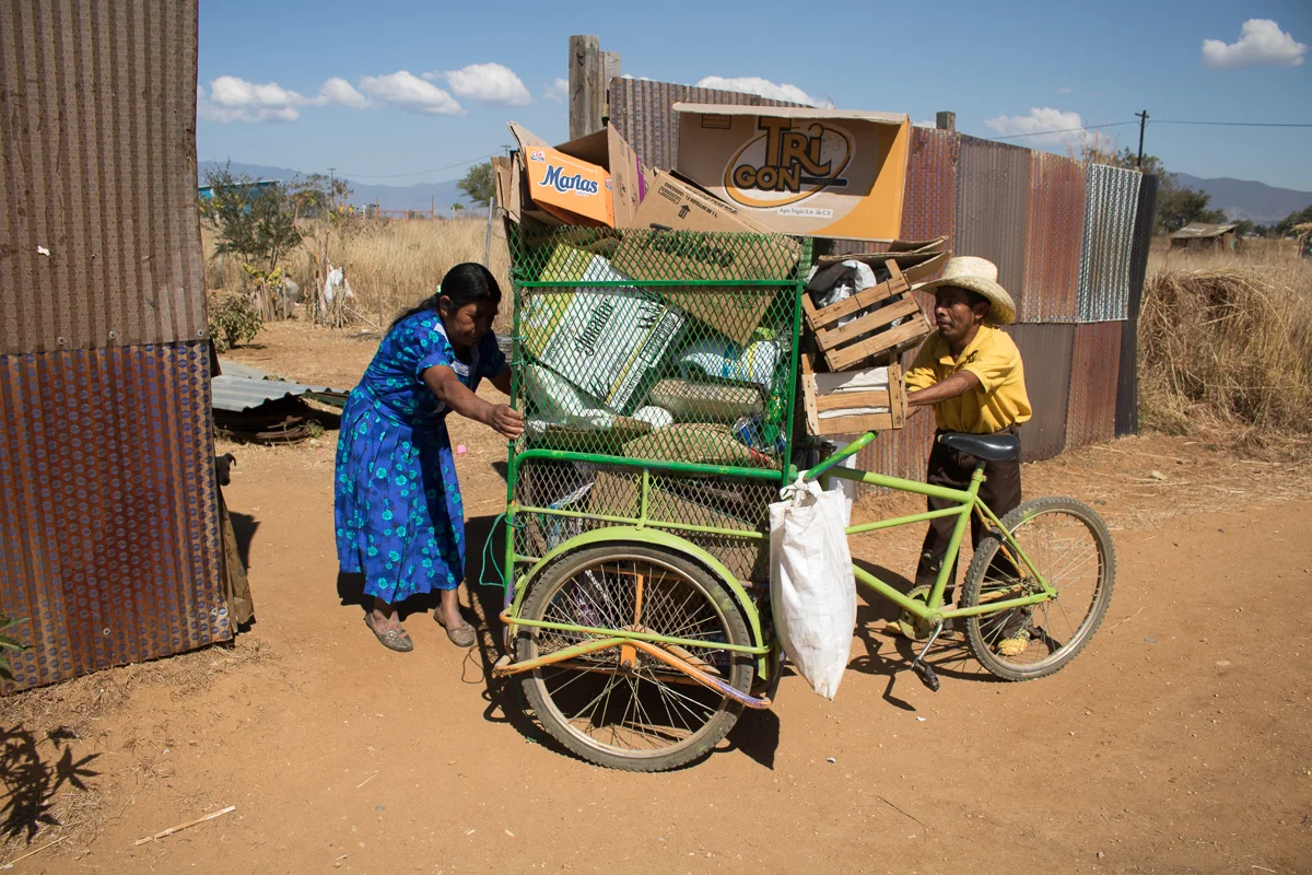 Auria Vargas, left, 63 helps her son, Eliseo Vargas, right, 35, as he returns home from collecting recyclables in Zaachila, Mexico on Friday, Jan. 13, 2017.