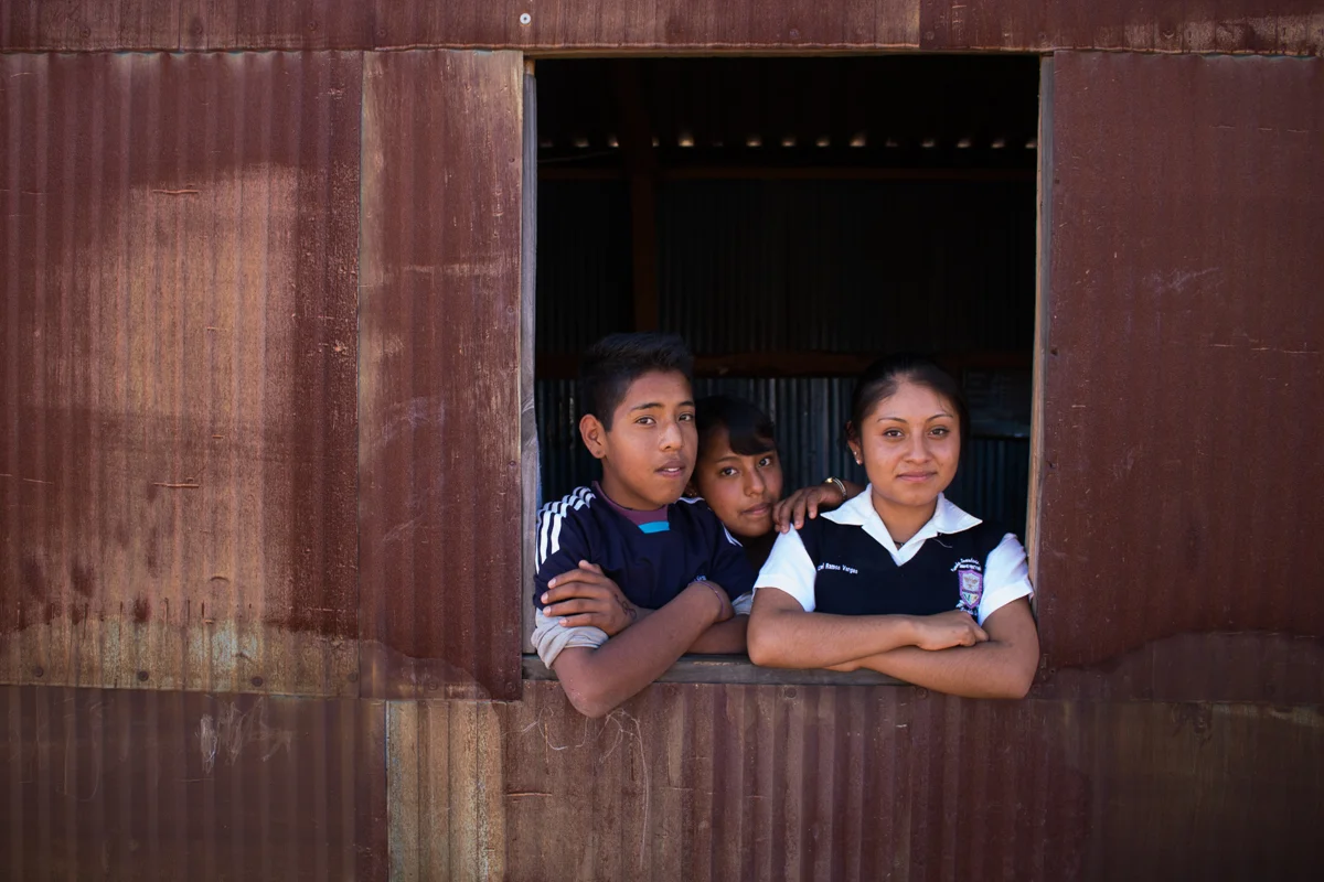Abdiel Vargas, 13, Yanitza Vargas, 13, and Deysi Vargas, 15, pose in the window of the family kitchen in Zaachila, Mexico on Thursday, Jan. 12, 2017.