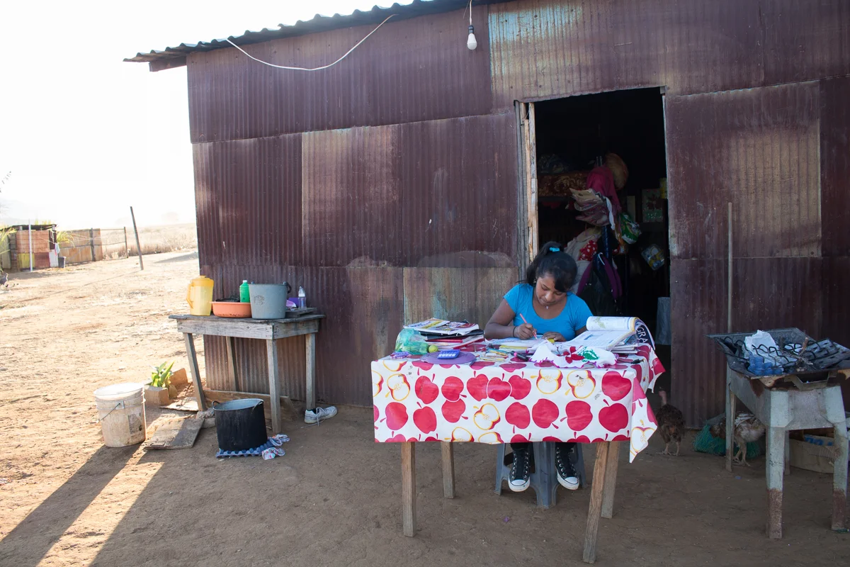 Yanitza Vargas, 13, does her homework outside of room in Zaachila, Mexico on Friday, Jan. 13, 2017.