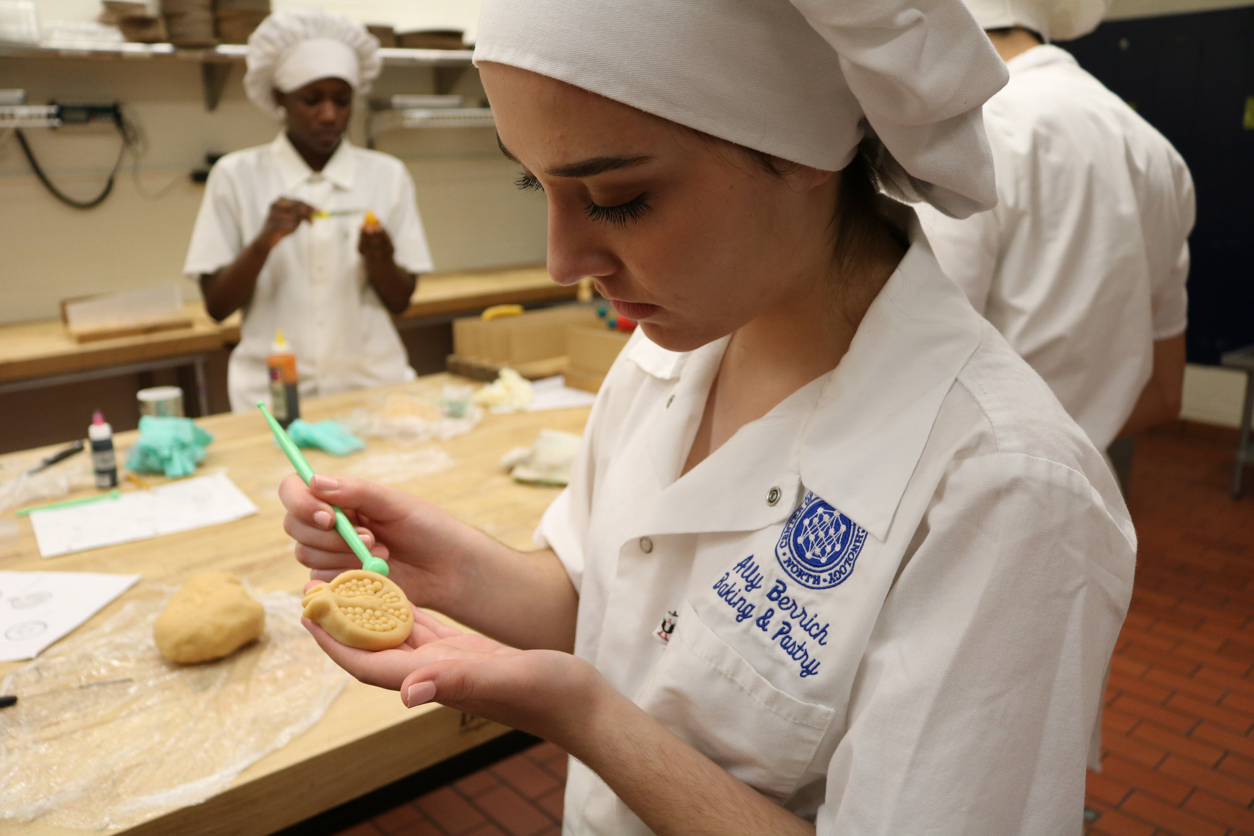   Ally Berrich, 17, forms a pomegranate out of marzipan in her baking and pastry course at the Center of Applied Technology North in Severn, Md., on May 5, 2016.  