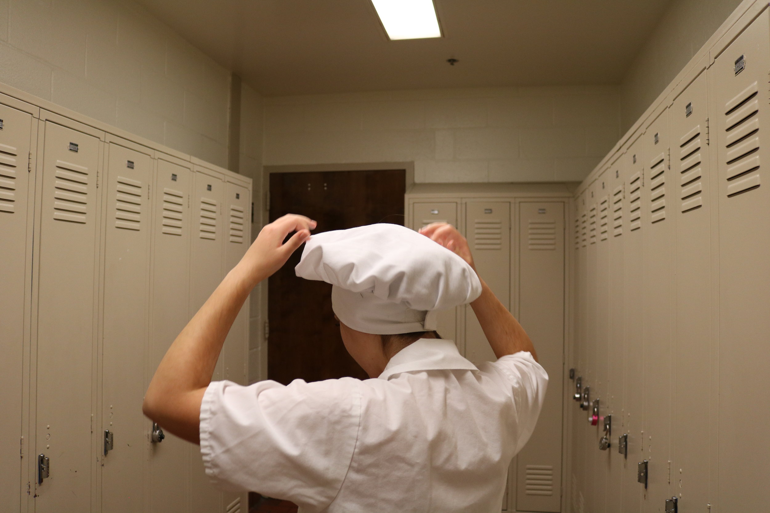   Ally Berrich, 17, removes her chef’s hat and prepares to go home after her baking and pastry class at the Center of Applied Technology North in Severn, Md., on May 11, 2016  