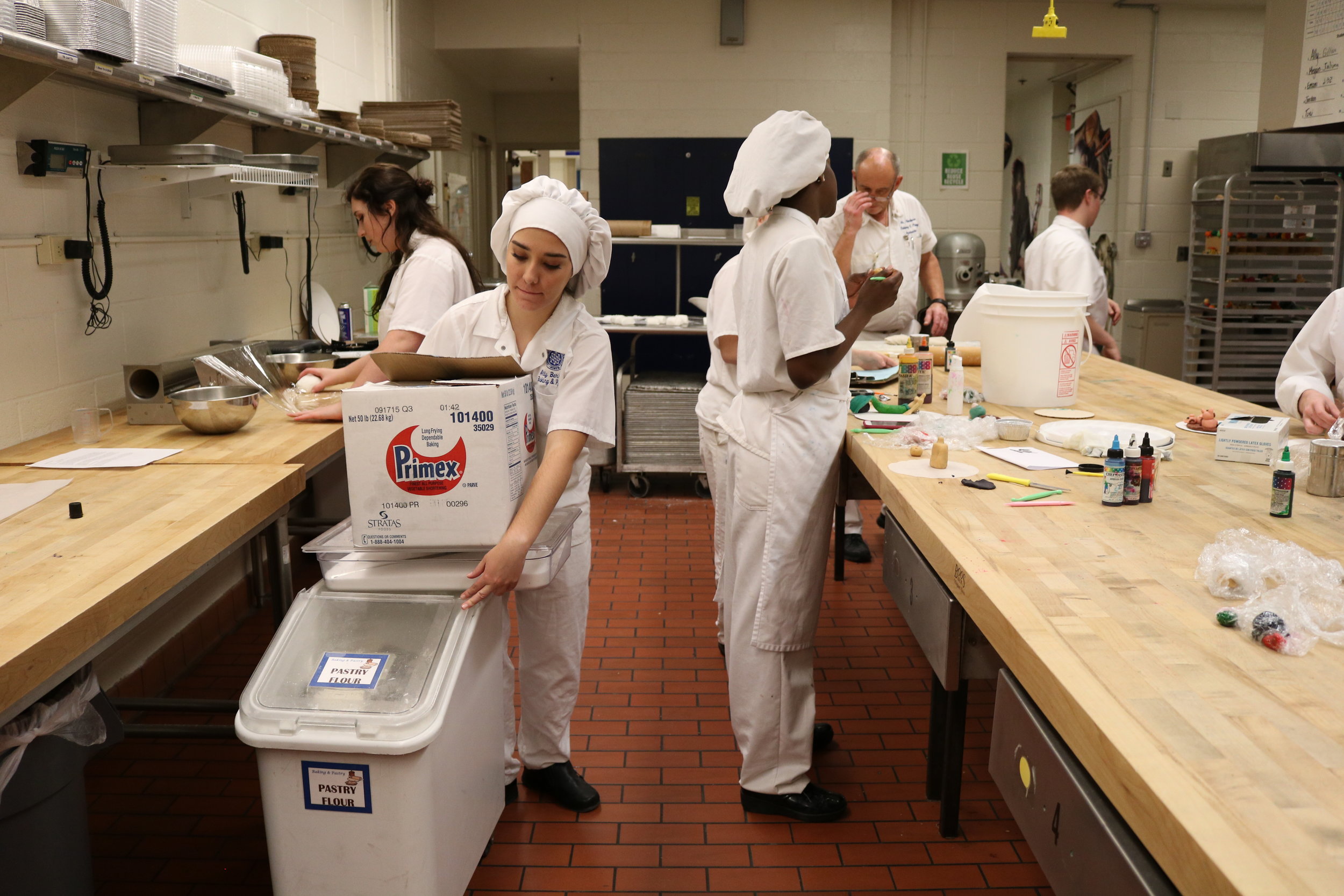   Ally Berrich, 17, gathers supplies to stay after her baking and pastry class at the Center of Applied Technology North in Severn, Md., on May 11, 2016.  