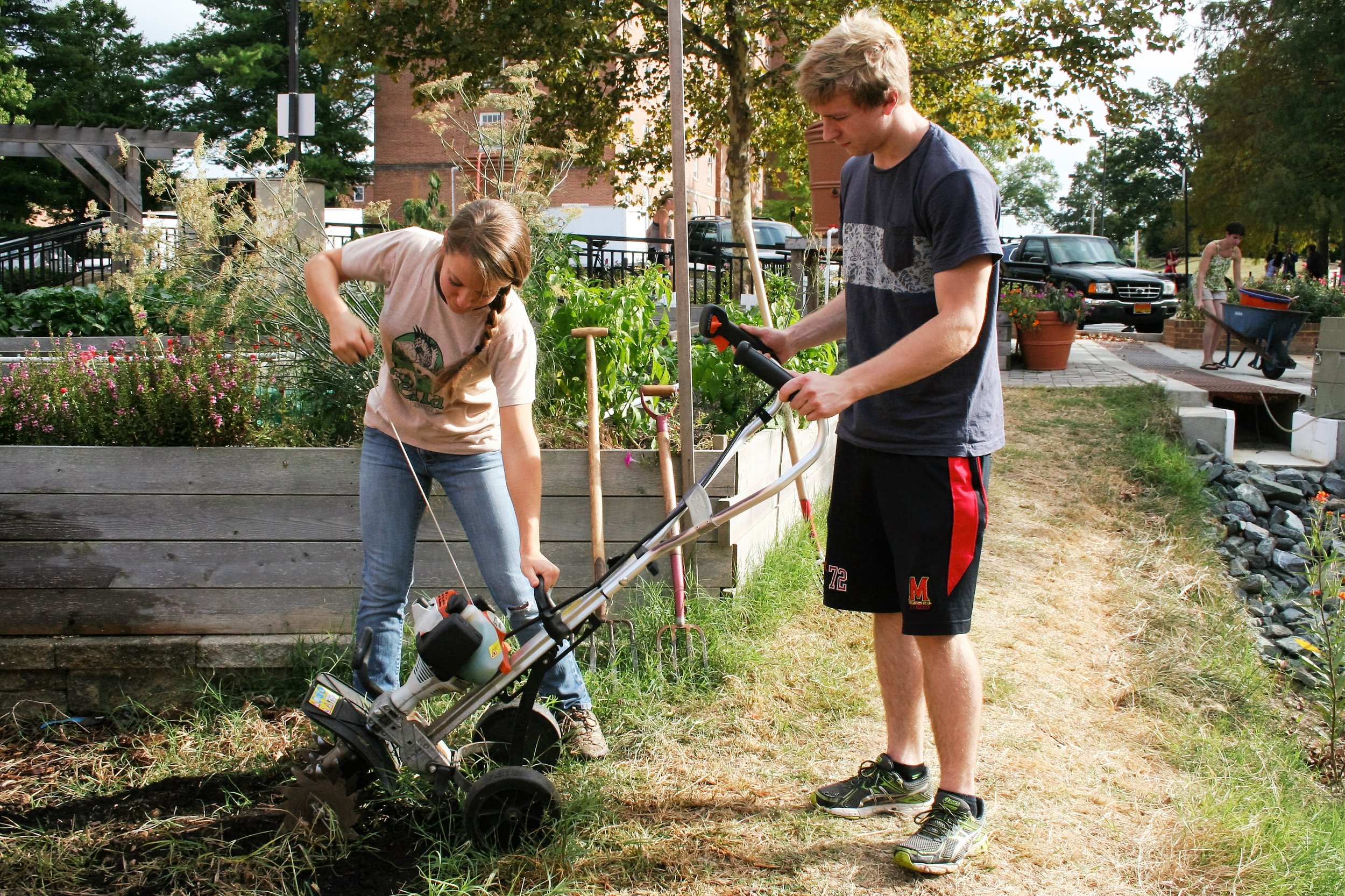  Meredith Epstein works with volunteer Philip Schwartz, a sophomore environmental and science technology major to start the engine of a plow to turn the fresh compost on Sept. 28, 2015. 