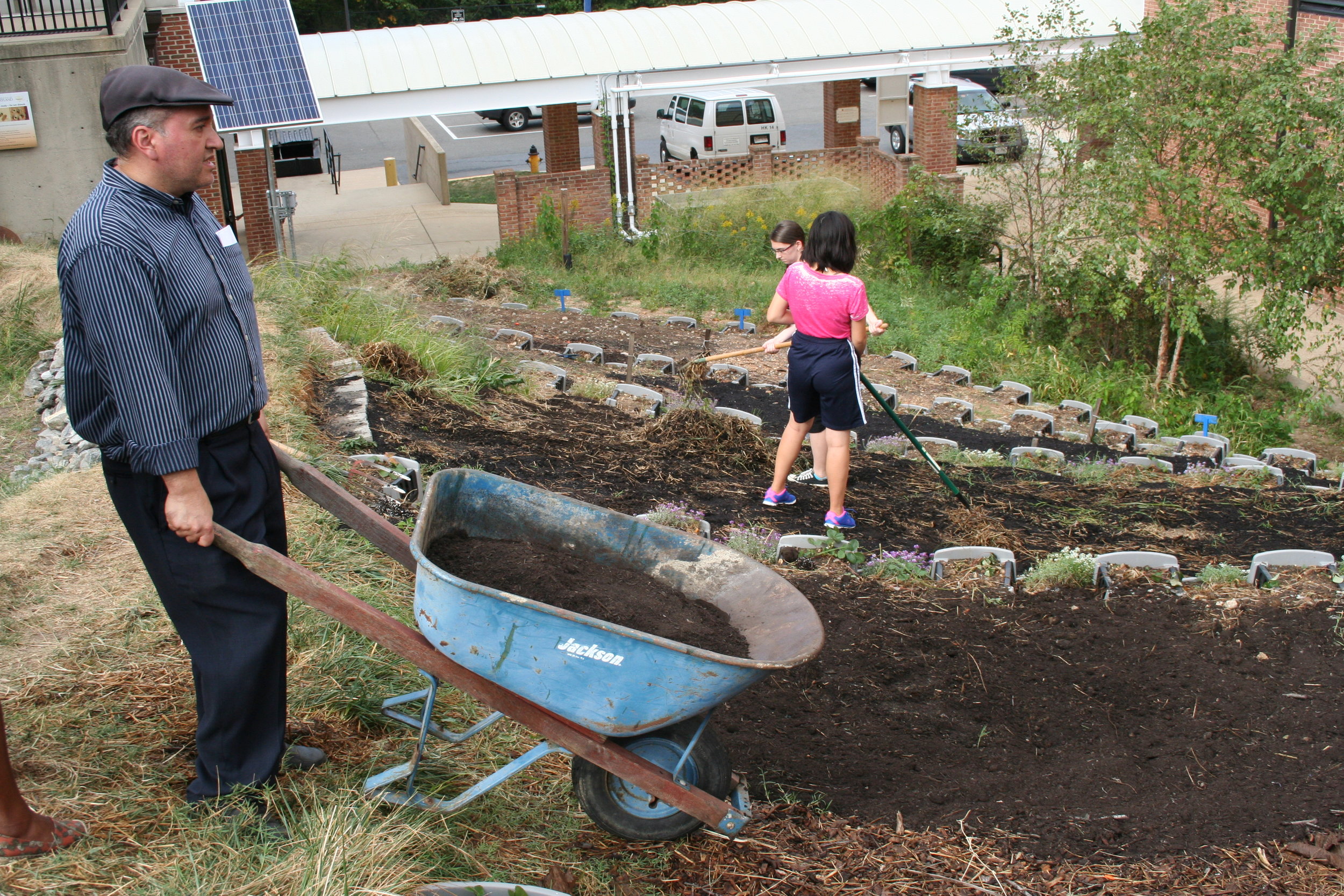  Edgar Moctezuma, a University of Maryland professor, brings more compost to the hillside of the garden which will be used as new foundation and fertilizer for the fall plants on Sept. 28, 2015. Moctezuma teaches a class called "Plants that Transform