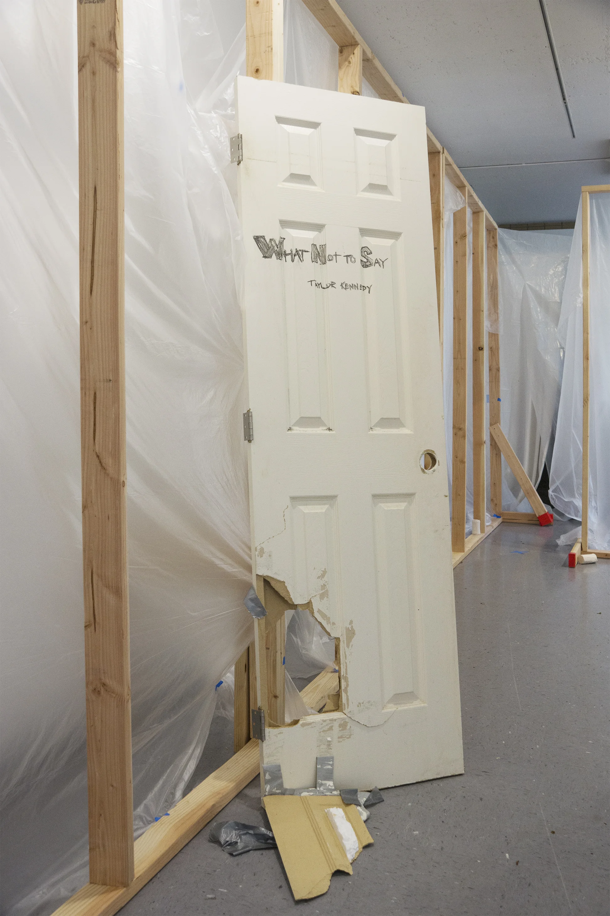 Title Door 2017 Found Discarded Door, 2x4’s, painter’s plastic and painter’s tape Dimensions Variable