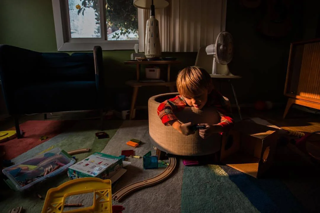 Orange-filtered sun created by terrible wildfires just north of us created an incredible, dramatic spotlight that fell directly on to my son. While playing on the floor it happened and I had to capture it - room a mess and all. We had been inside for several days due to bad air quality and the story this image tells will remind me of the time and place. 