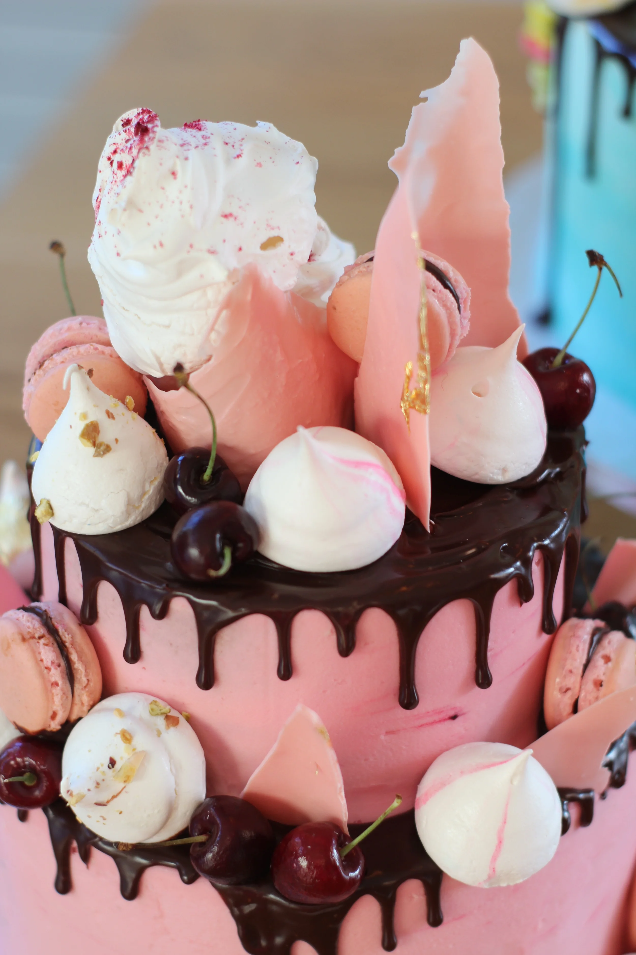 Glossy fresh cherries and freeze-dried raspberries add depth of colour to this pink two-tier cake.