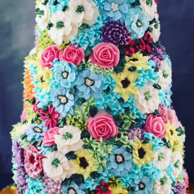 Buttercream cake smothered in bright florals £665.
