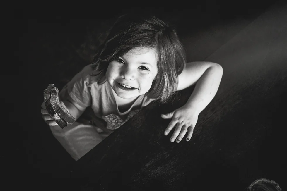 smiling at the camera in black and white