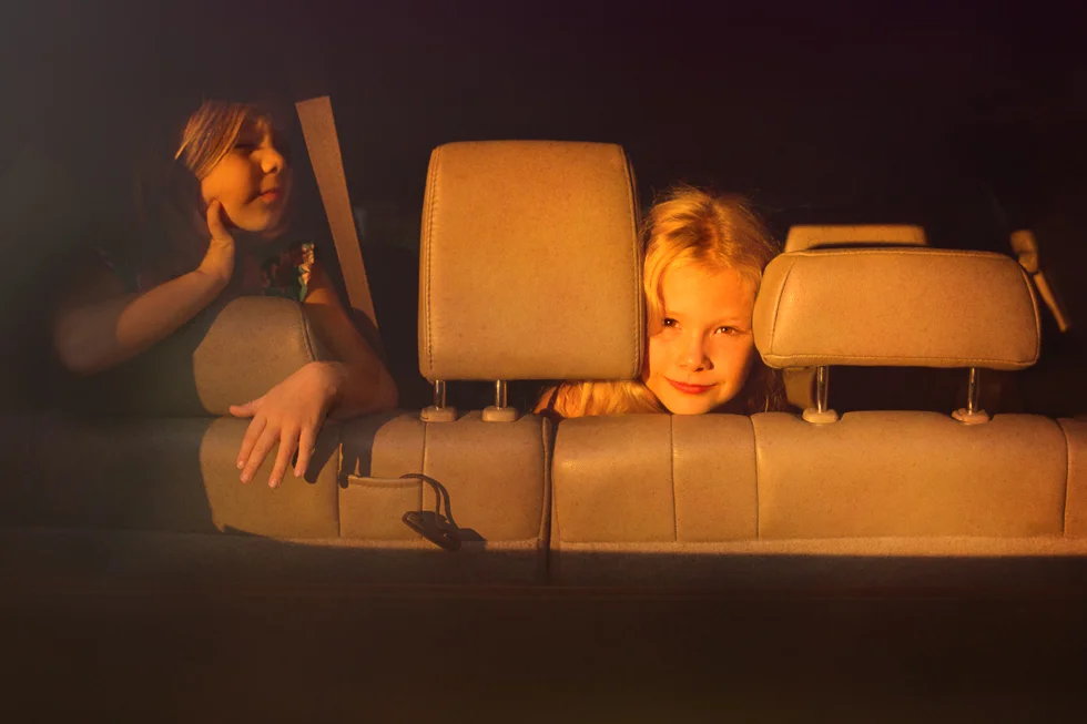 girls in car bathed in golden sunset