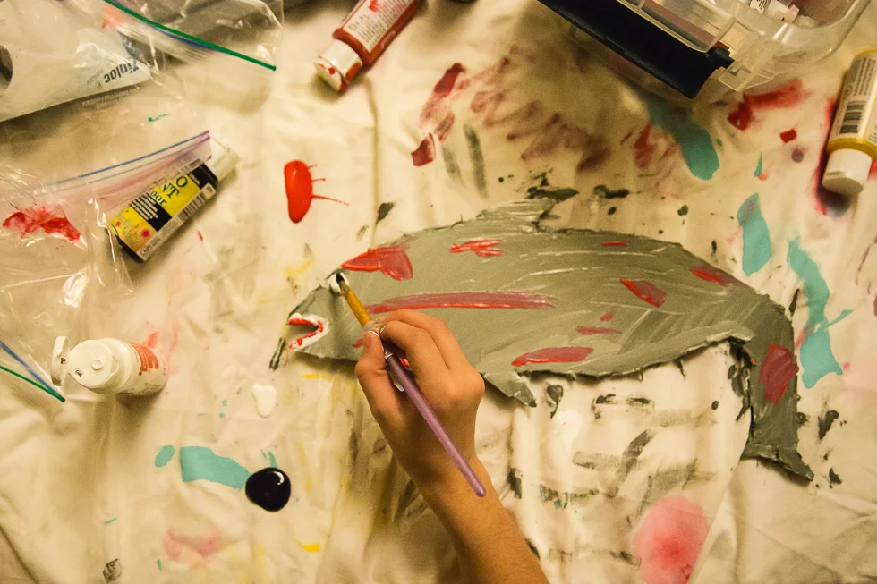 child painting an art project of a shark