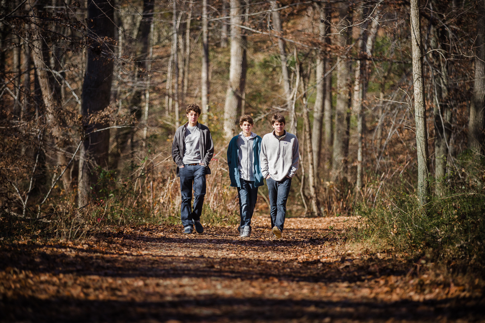 Copy of Teenage boys walking through the woods.