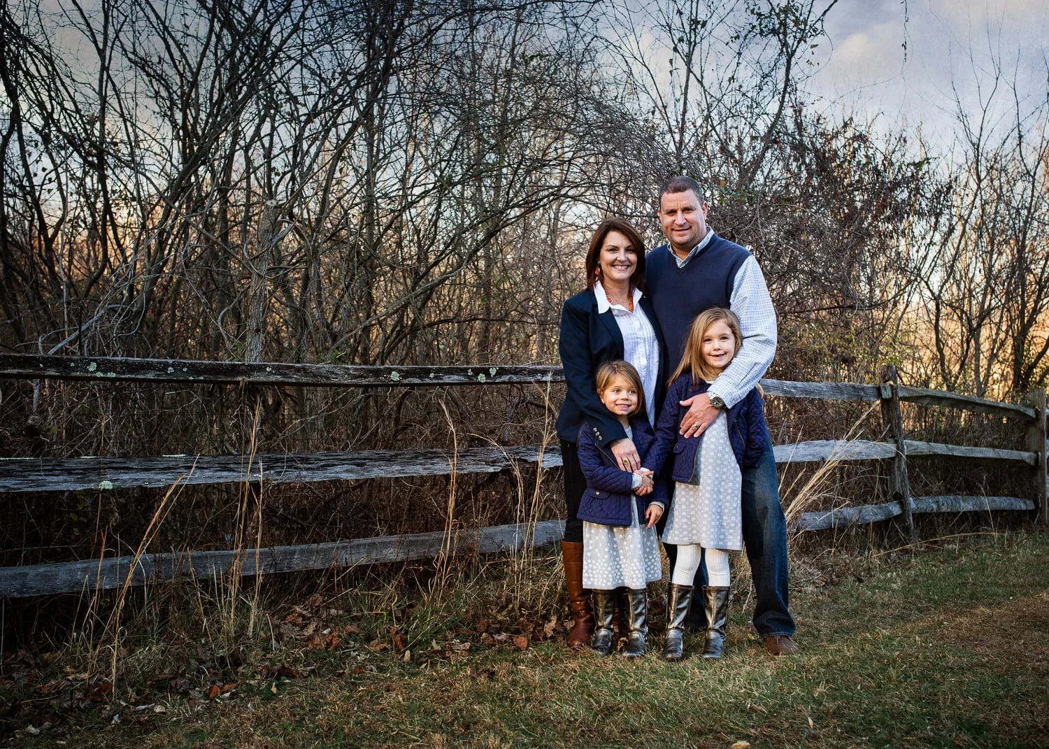 Photograph of mother, father and two girls by fence in Hunt Valley, MD