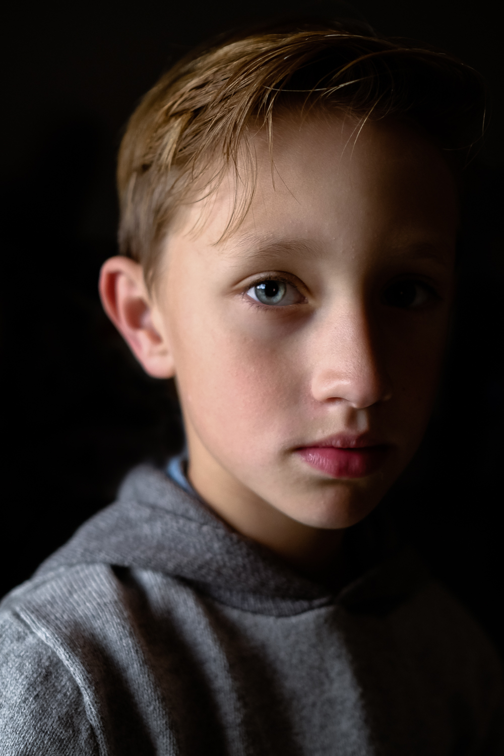  side lit portrait of blonde young boy 