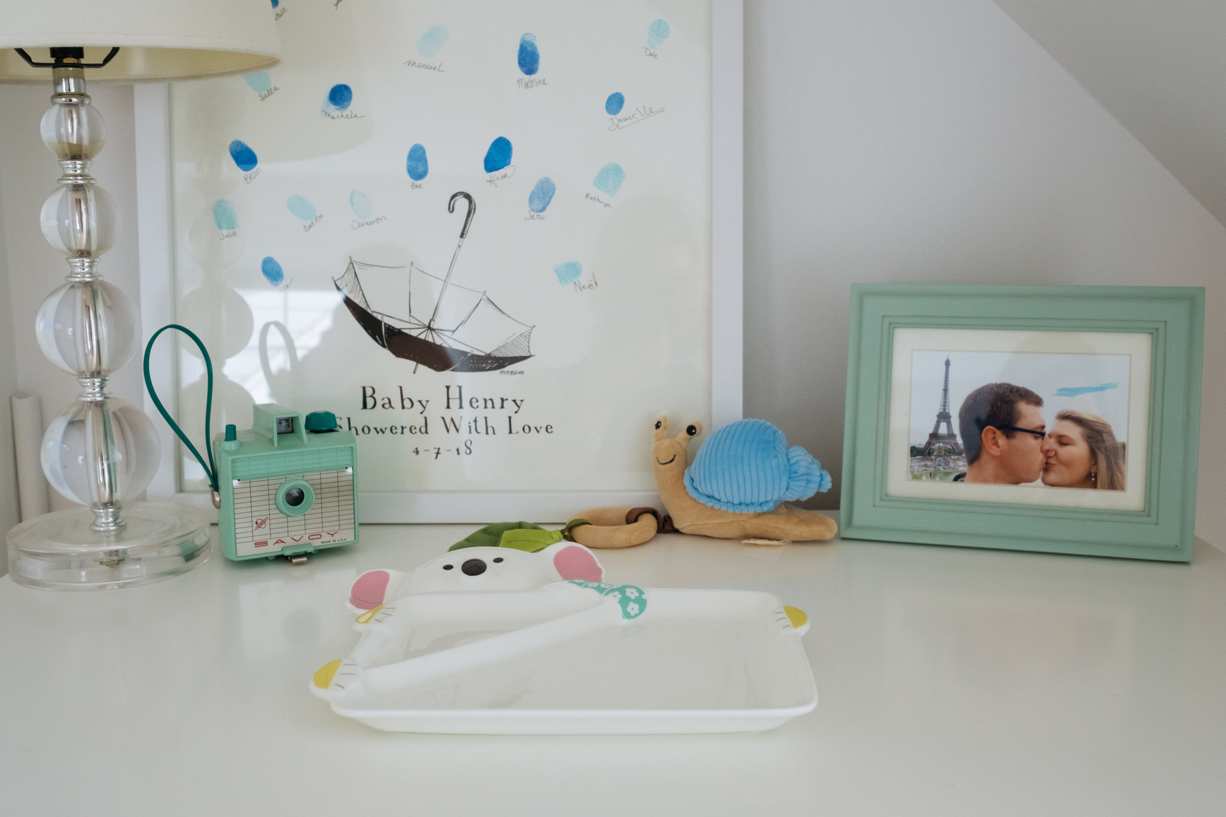 dresser display of special items and art in newborn nursery