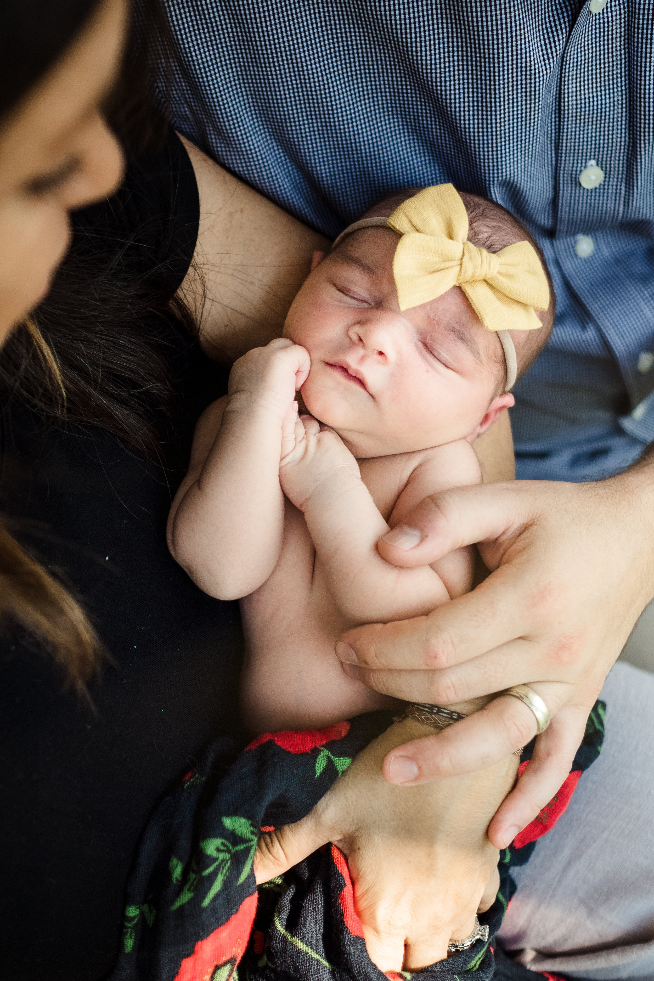 portrait of sleeping newborn baby girl wearing yellow headband bow