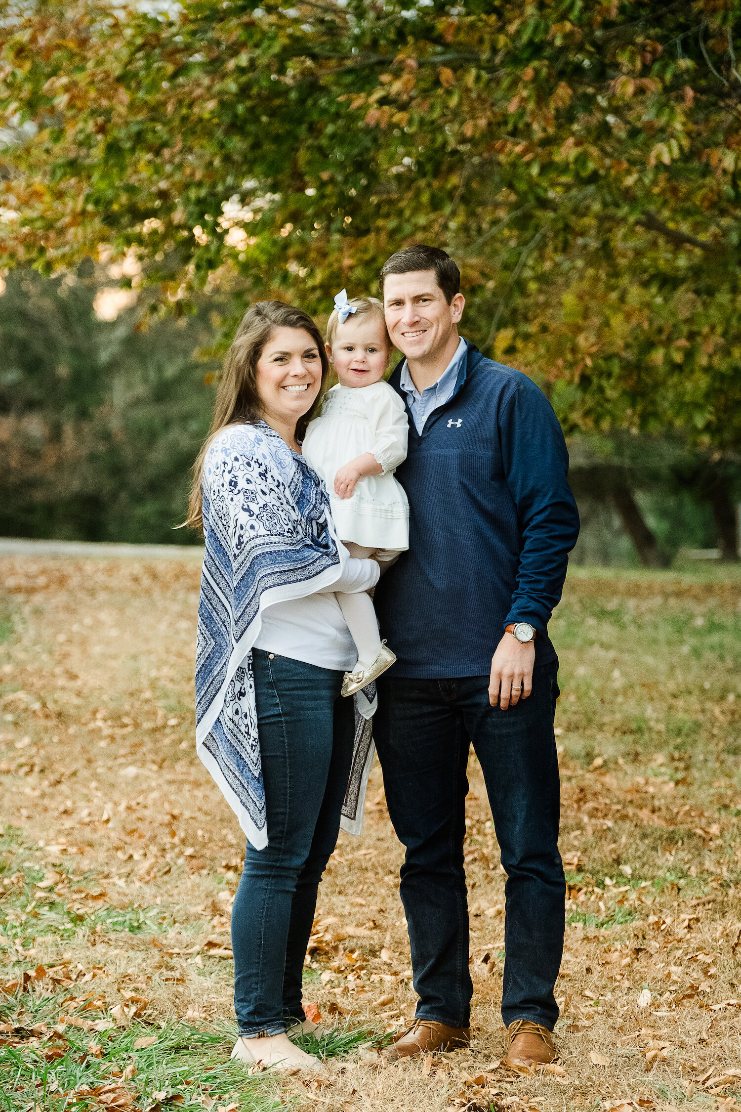professional family portrait of parents holding adorable one year old little girl in Towson Maryland