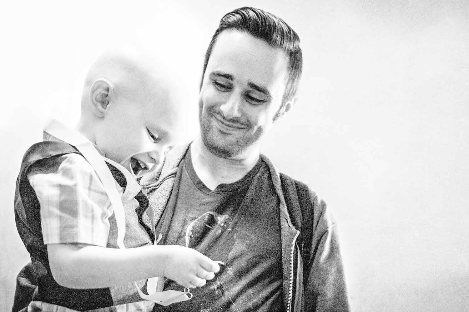 dad-holding-son-who-received-medal-for-final-cancer-treatment.jpg