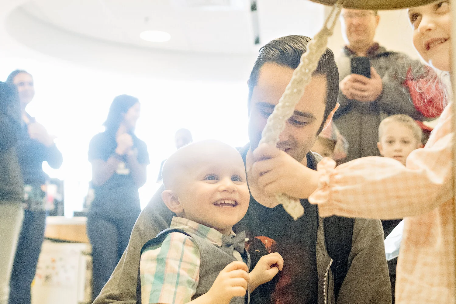 little boy rings bell at johns hopkins childrens cancer center.jpg