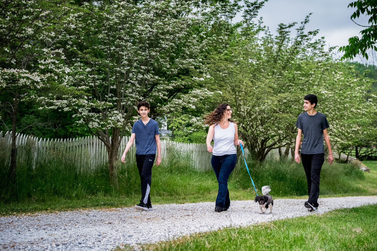 mom-and-two-teen-sons-walking-with-her-dog.jpg