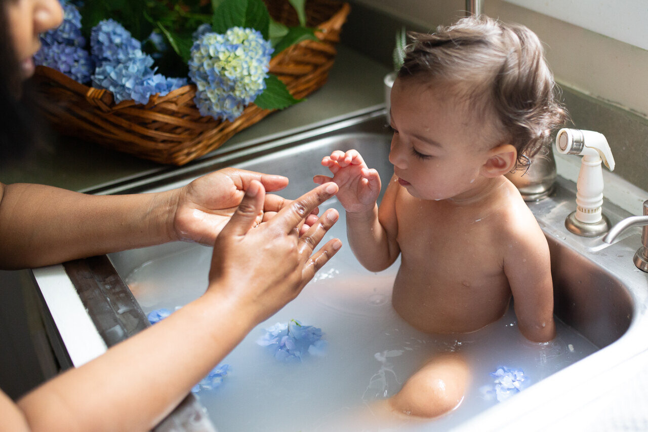 baby_in_sink_milk_bath_with_mothers_hands.jpg