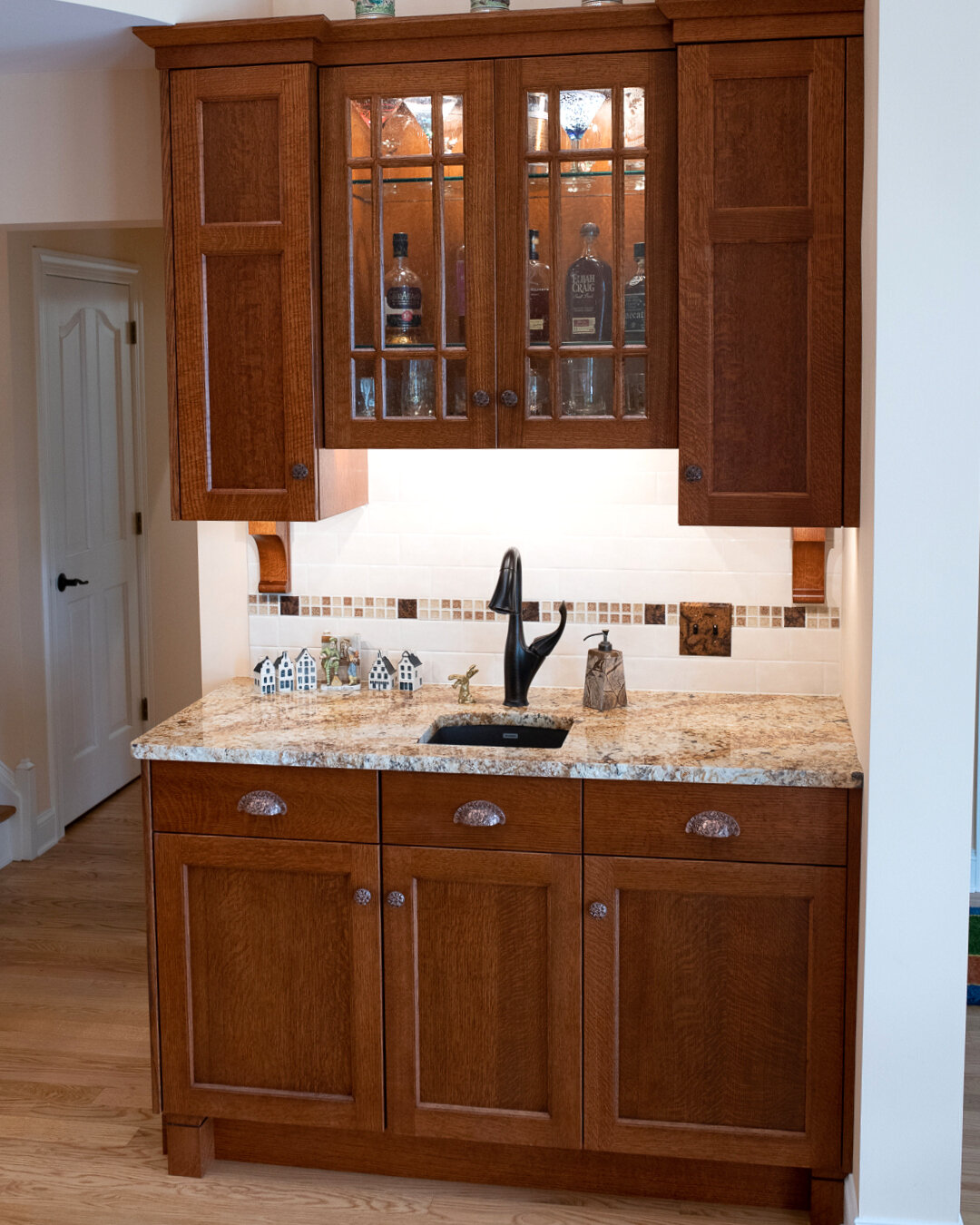 Blanco faucet and bar sink with subway tile back splash. Crackle glass and hand-covered copper listello border tile accent.