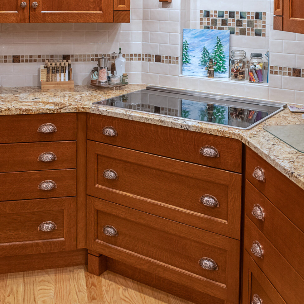 Spacious storage drawers in cooktop area with Florid Leaves Bin Pulls.jpg