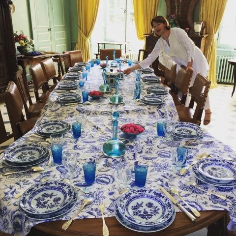 Marie Saint Bris sets the table for "le dîner bleu" in the dining room of her family's Château Beauchêne in France's Loire River Valley .