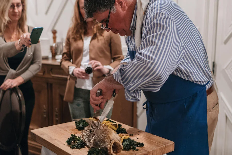 Dickie Brennan carves up the redfish courtbouillon for dinner at Tableau. Credit Paul Broussard