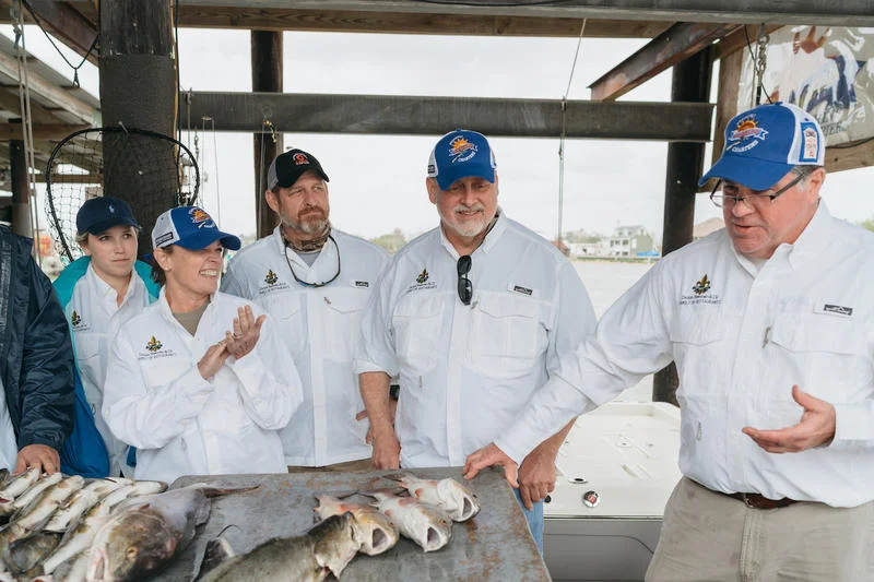 Poppy Tooker, chefs from the Dickie Brennan Restaurant Group and Dickie Brennan show off their catch of the day. PAUL BROUSSARD