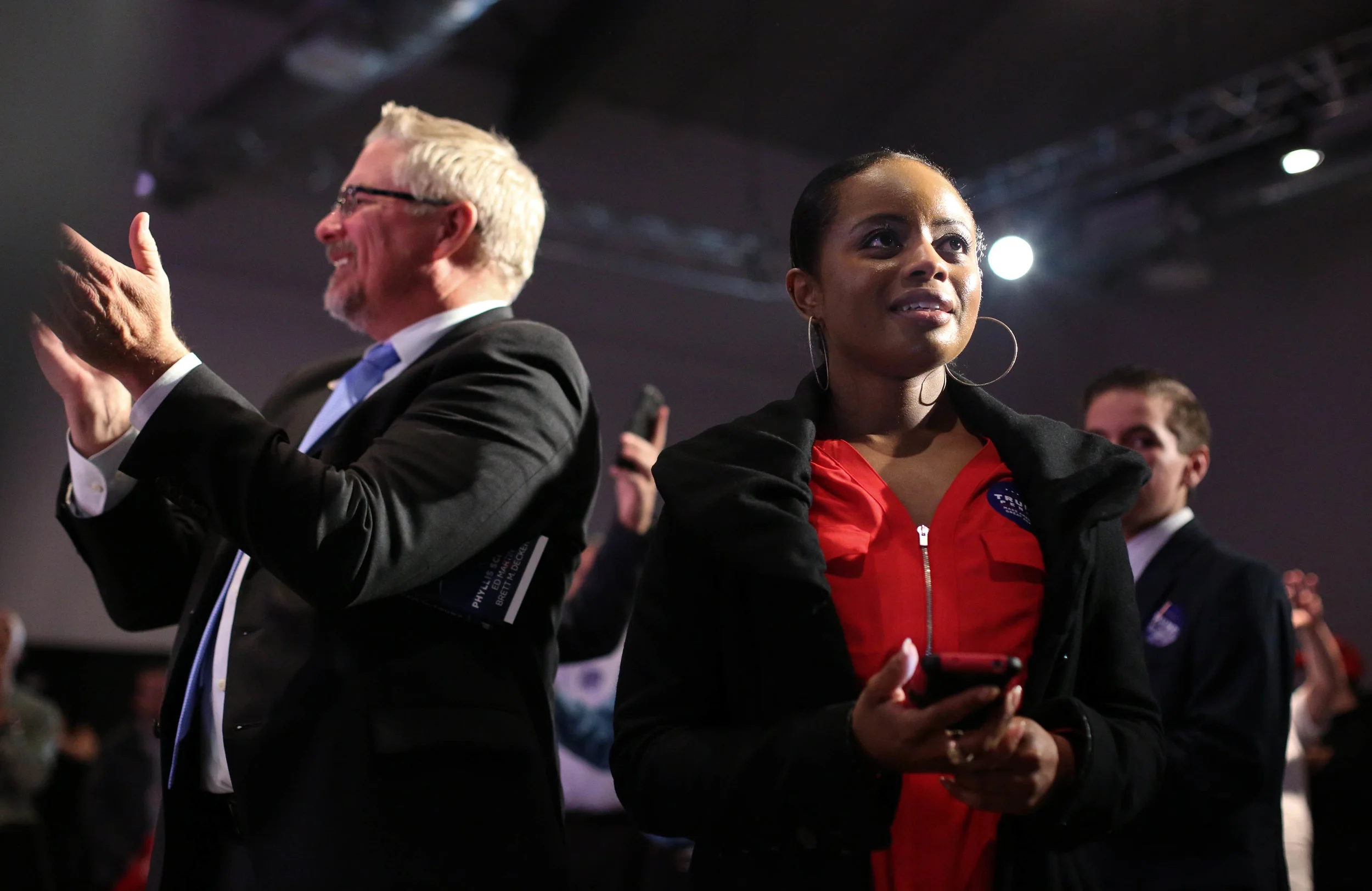 Parson Hicks (right), 35, reacts to Fox News election results during the Massachusetts Trump-Pence Campaign victory party at the F1 Boston race track. 