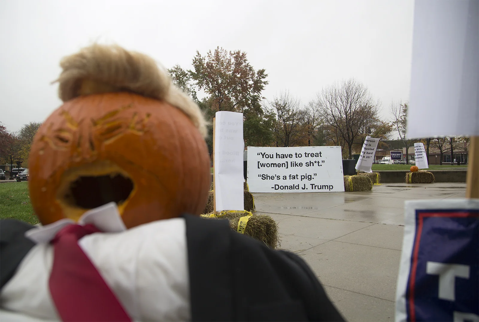 Protesters display signs outside of the Radisson Hotel in downtown Manchester, N.H.