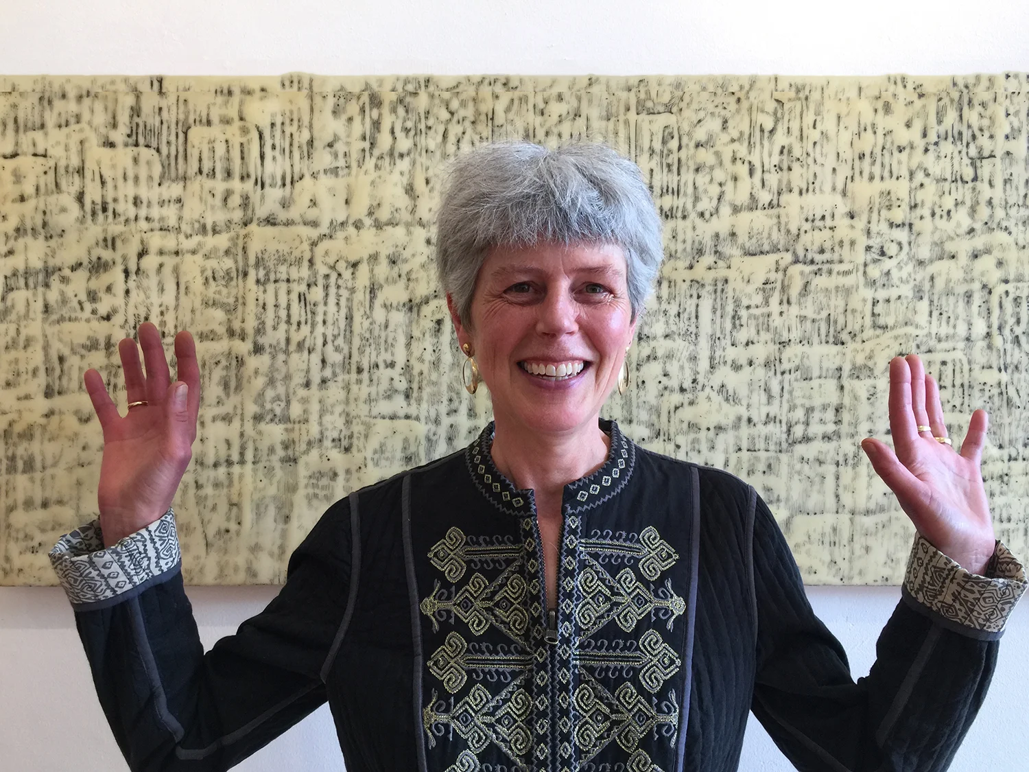 And our very own fantastic gallery owner, Anne , standing in front of a piece by Mari Marks .