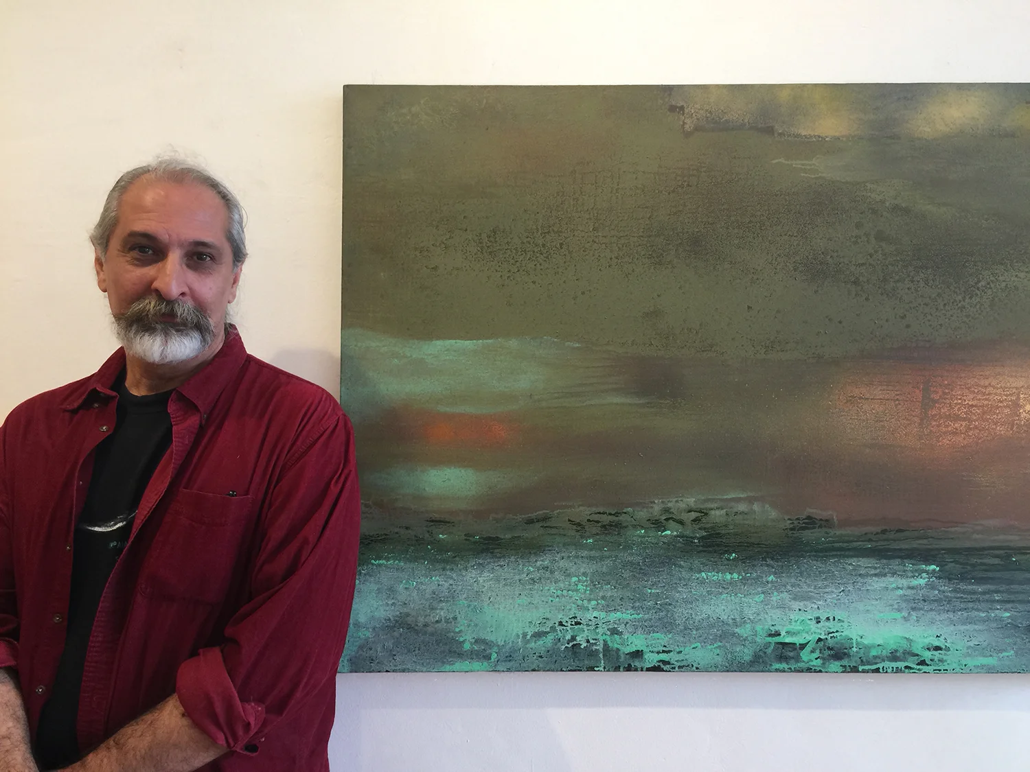Yari Ostovany with his painting Oracle II