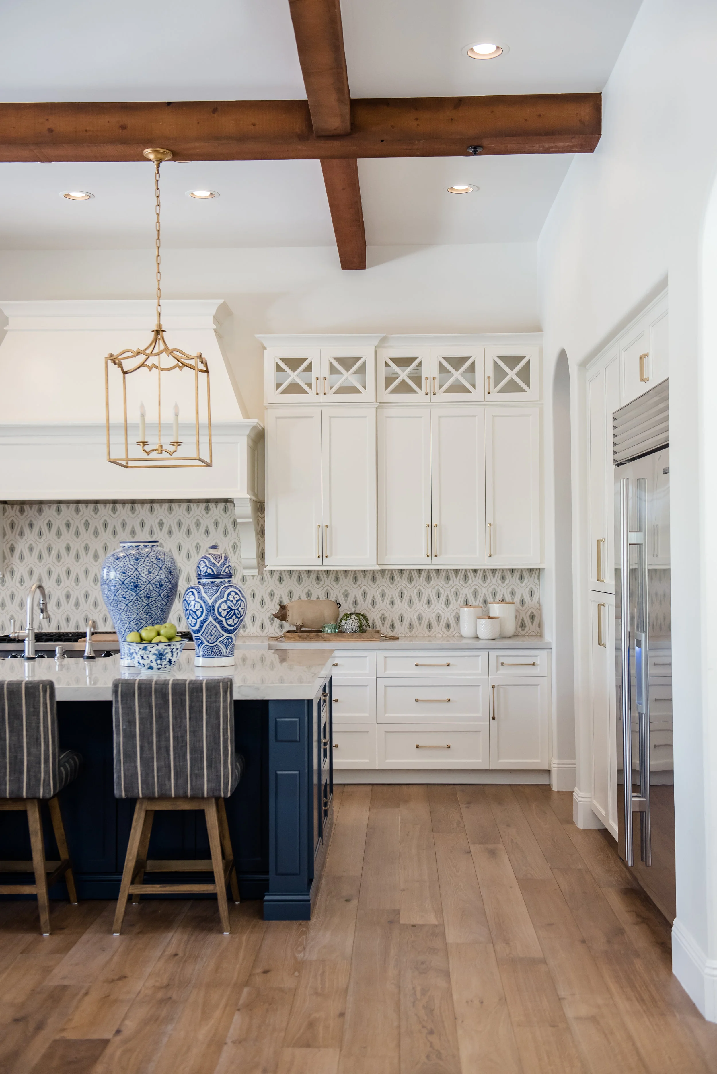 23a+kitchen+hood+pots+stripedstools+navyblueisland+backsplashtile+openshelves+pendants+brasslighting.jpg