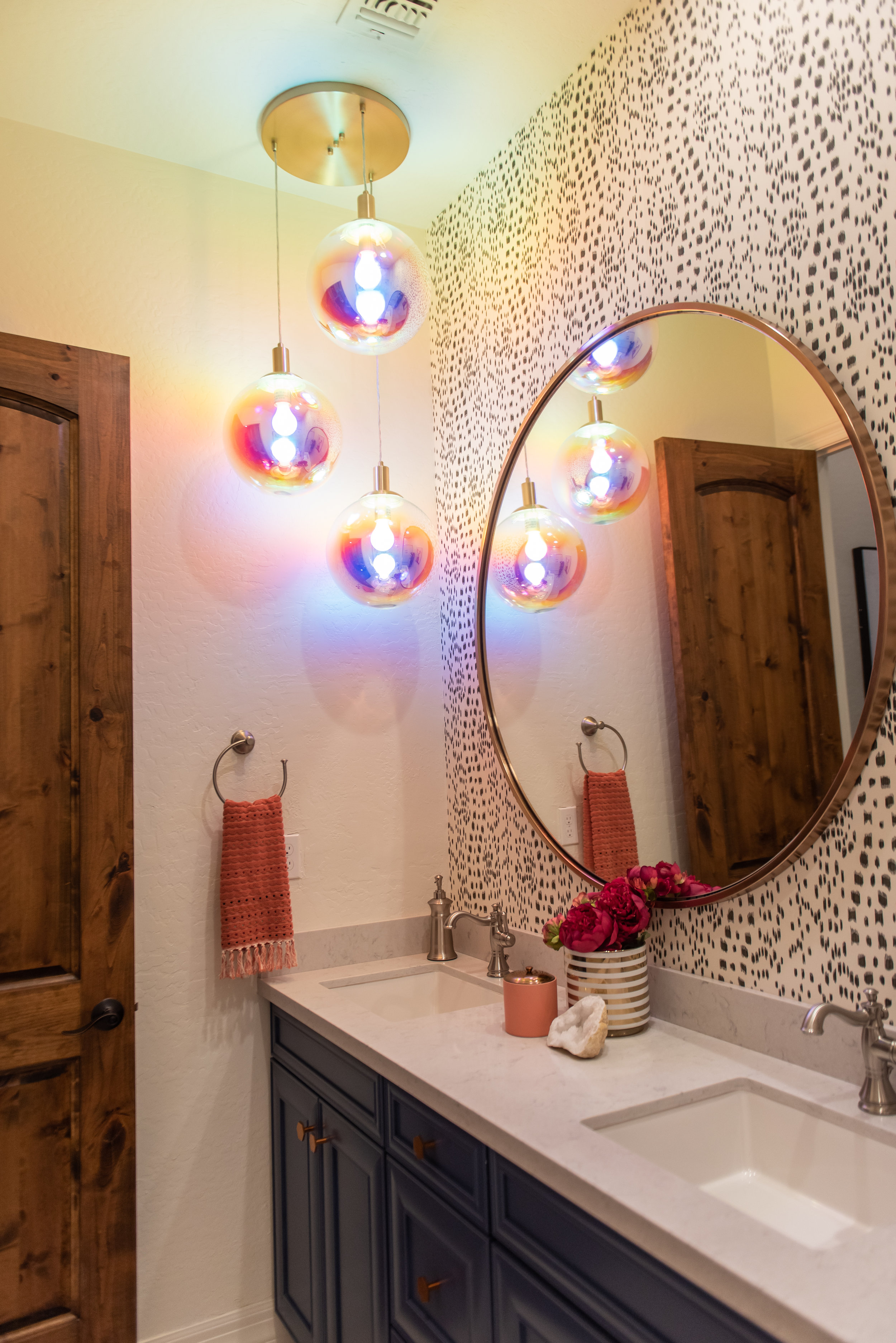 girls bathroom +round +mirror +lighting +wallpaper.jpg