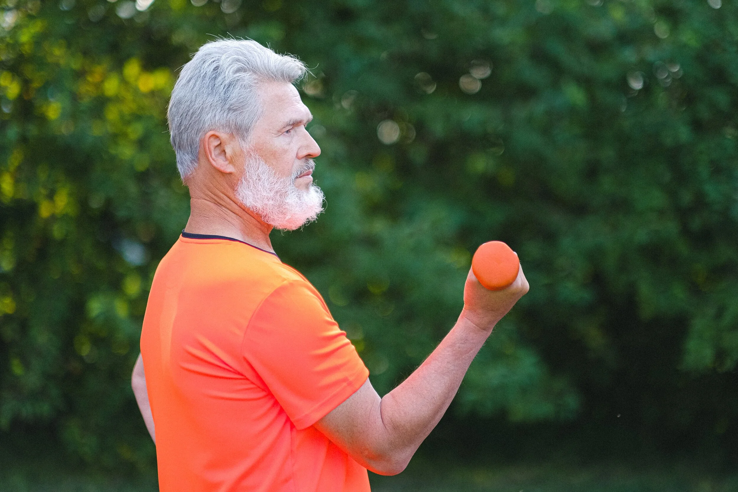 An aging adult lifting dumbbells